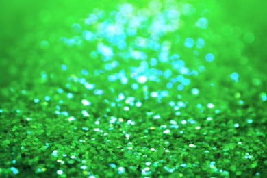 Image of St. Patrick day. Shiny green glitter, closeup. Bokeh effect