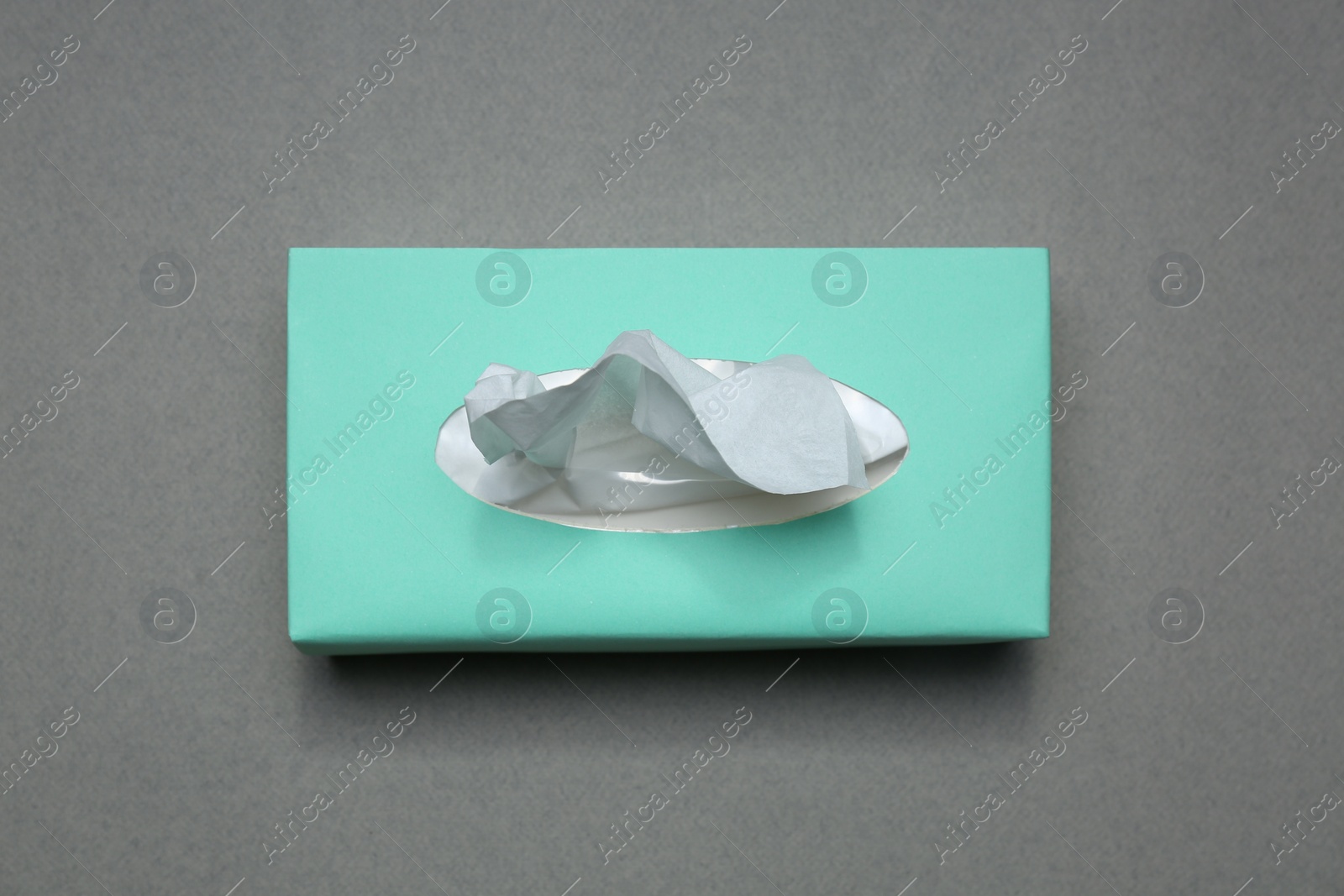 Photo of Box of paper tissues on grey background, top view