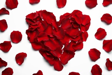 Photo of Beautiful heart of red rose petals on white background, top view