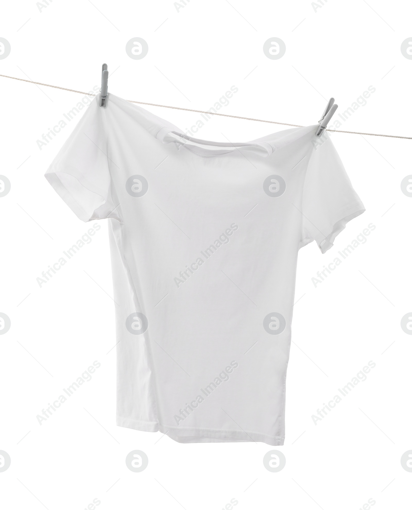 Photo of One t-shirt drying on washing line isolated on white