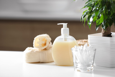 Photo of Composition with soap dispenser on white table indoors