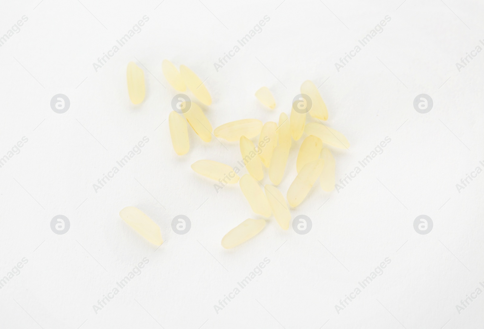 Photo of Uncooked rice on white background, top view