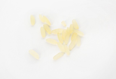 Uncooked rice on white background, top view