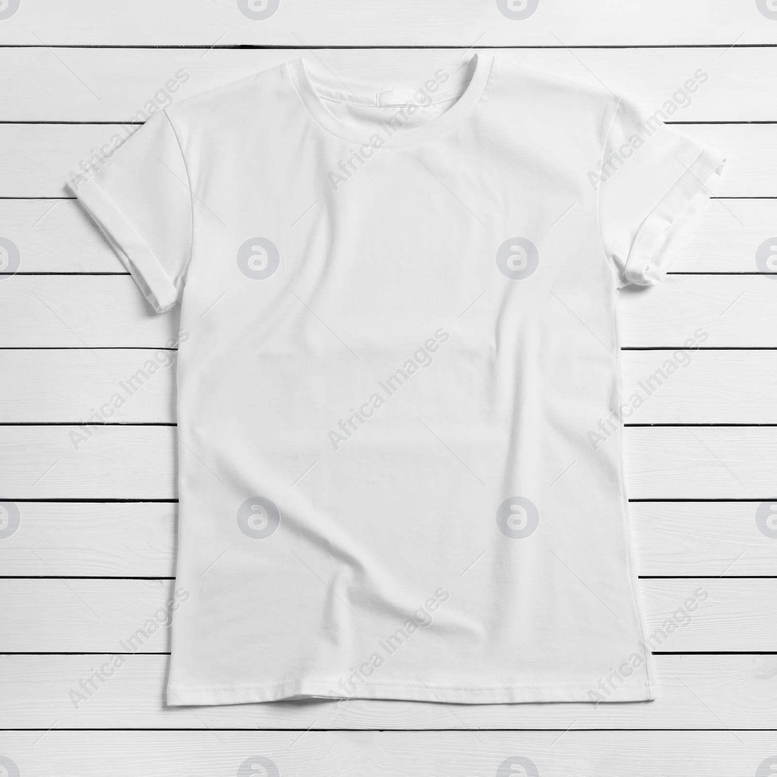 Photo of Stylish t-shirt on white wooden background, top view