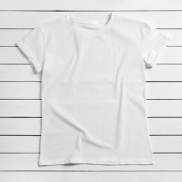 Stylish t-shirt on white wooden background, top view