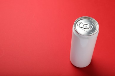 Photo of White can of energy drink on red background. Space for text