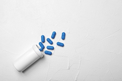 Photo of Bottle with pills on gray background