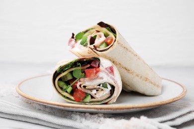 Photo of Delicious sandwich wraps with fresh vegetables on table, closeup