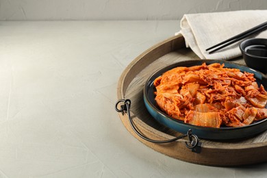 Photo of Delicious kimchi with Chinese cabbage and sauce on light grey table, space for text