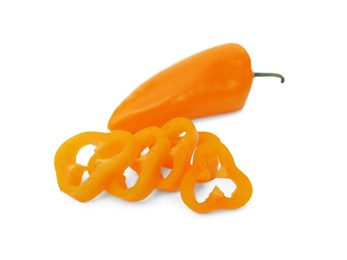 Photo of Cut and whole orange hot chili peppers on white background