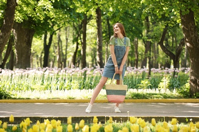 Photo of Beautiful young woman in green park on sunny spring day