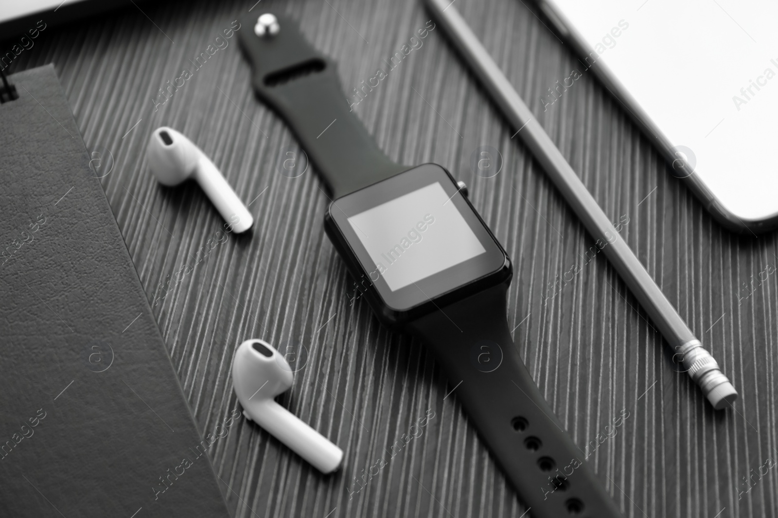 Composition with stylish smart watch on black table Photo of Composition with stylish smart watch on black table