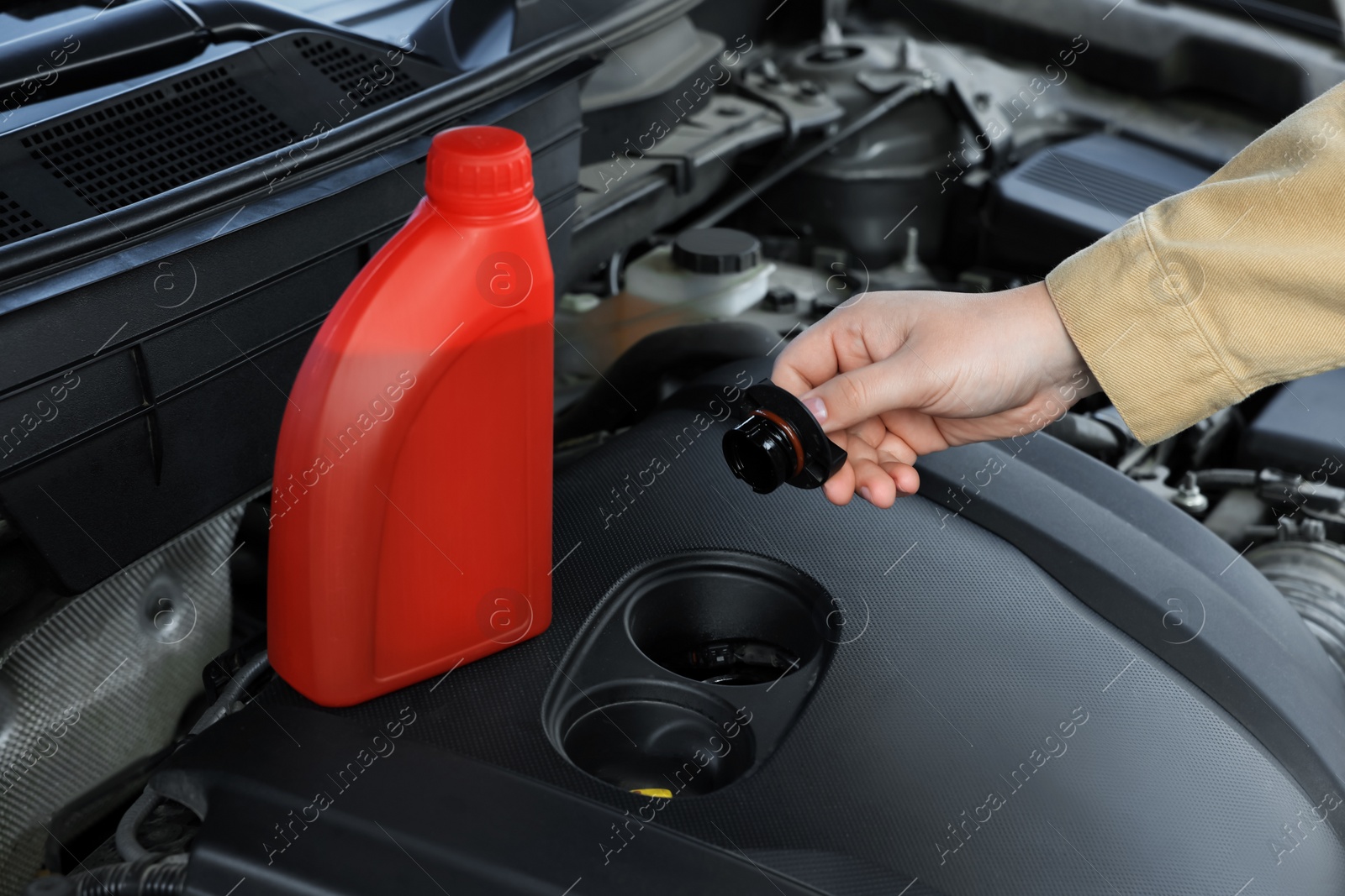 Photo of Man checking motor oil level in car, closeup