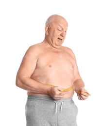 Fat senior man with measuring tape on white background. Weight loss