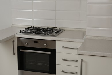 Photo of New gas stove and oven in stylish kitchen