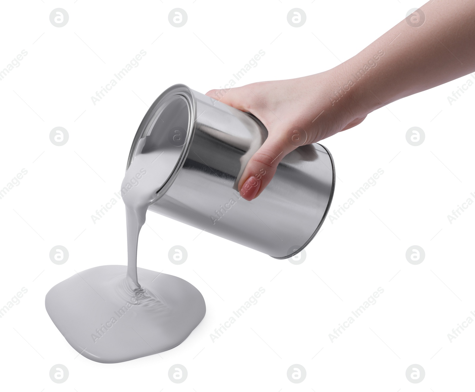 Photo of Woman pouring paint from can on white background, closeup