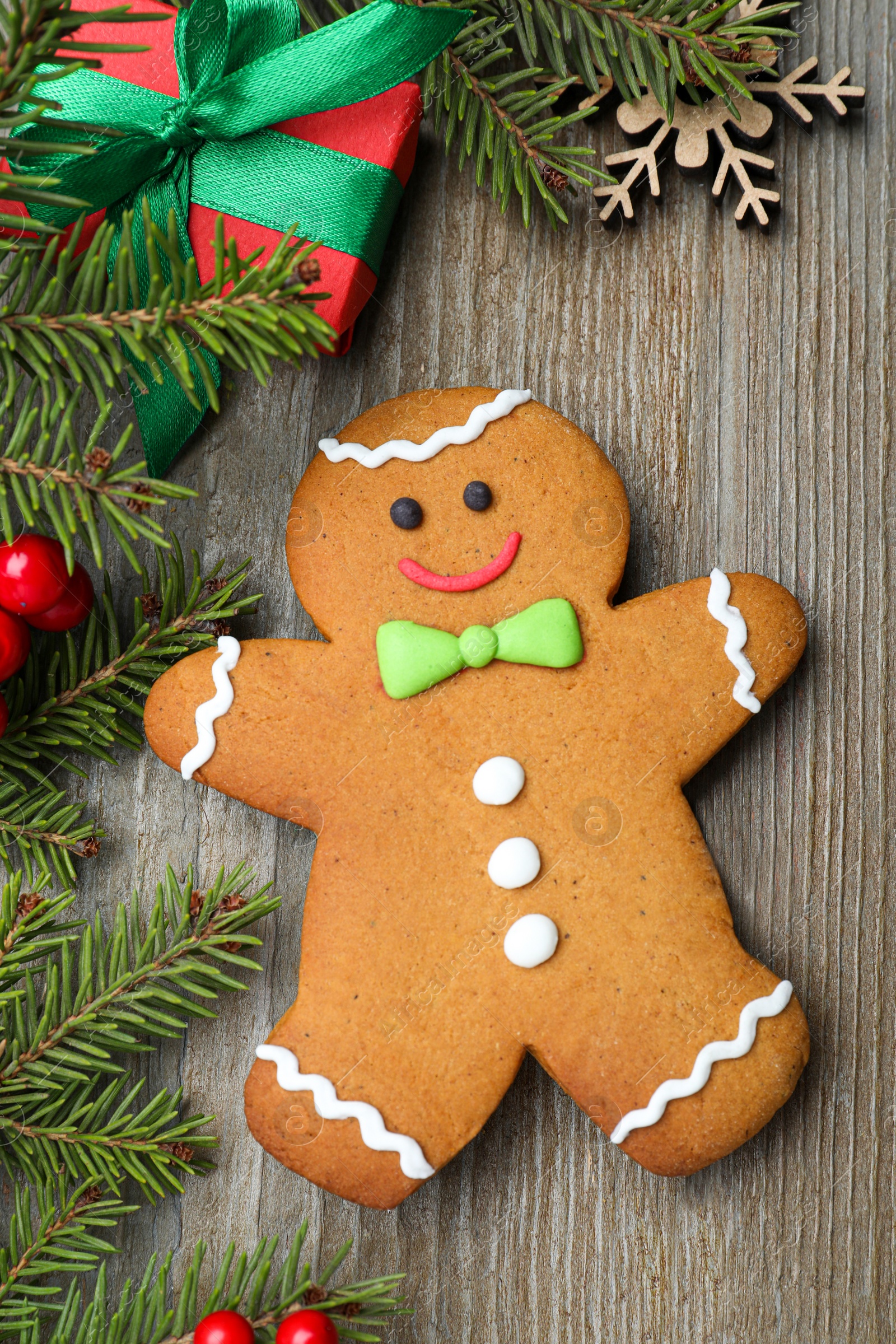 Photo of Flat lay composition with gingerbread man on wooden table