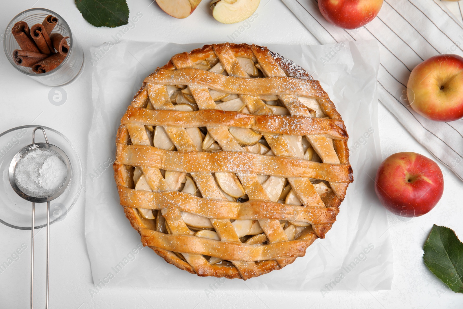 Photo of Delicious traditional apple pie on white table, flat lay