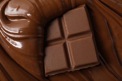 Tasty milk chocolate paste and pieces as background, top view