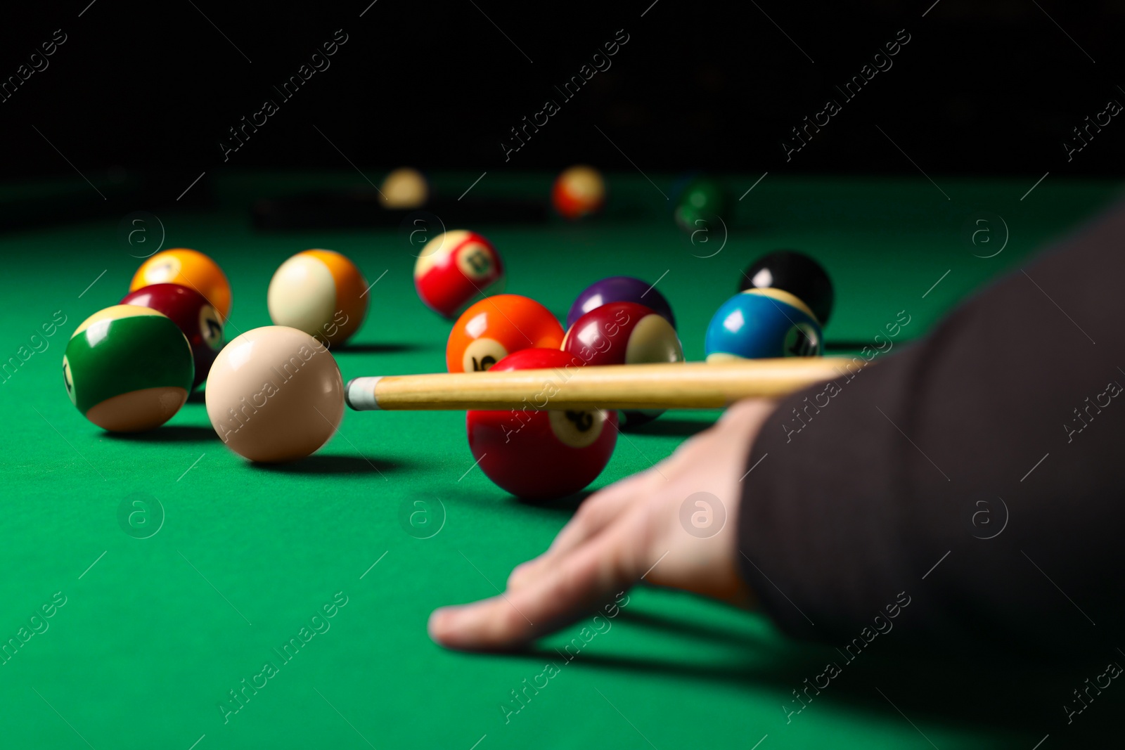 Photo of Man playing billiard at green table, closeup