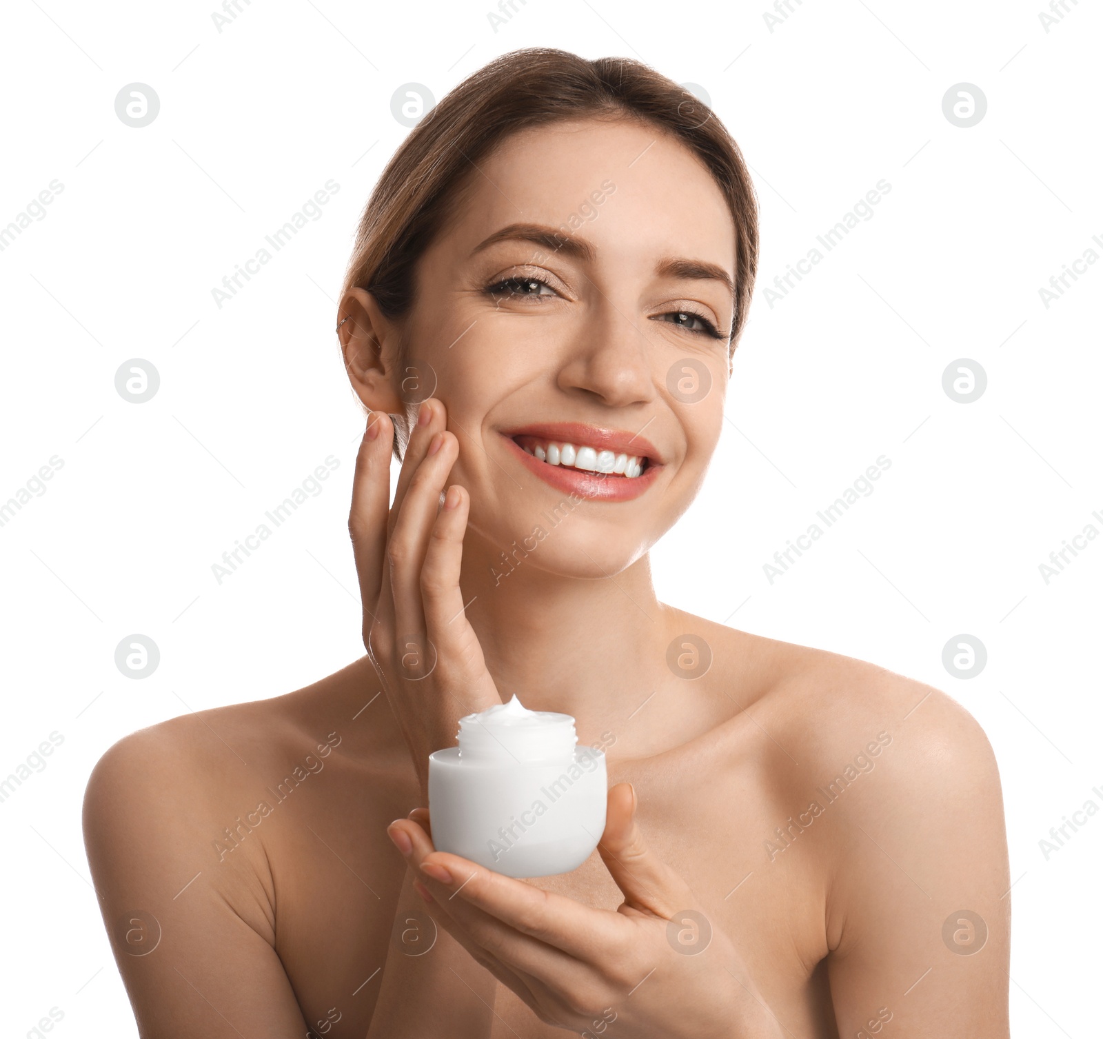 Photo of Young woman applying facial cream on white background