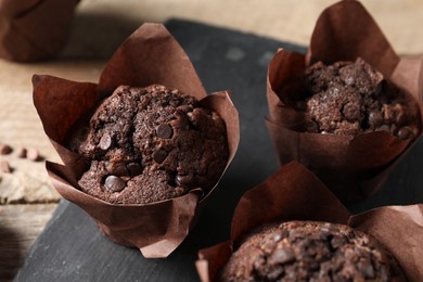 Photo of Delicious chocolate muffins on table, closeup view