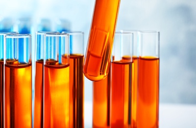 Photo of Taking test tube with liquid sample, closeup