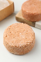 Photo of Natural solid shampoo bars on light table