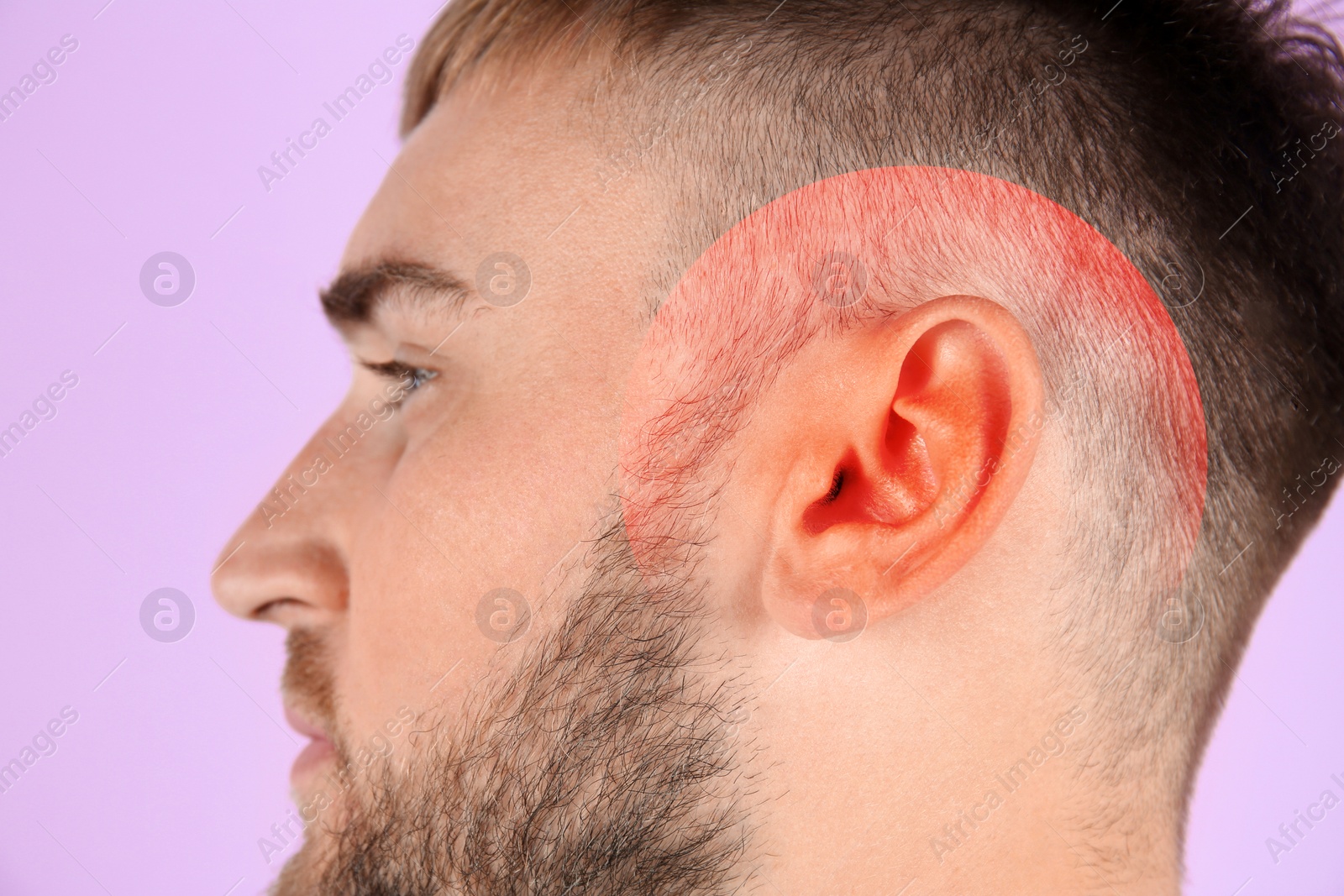 Image of Young man with hearing problem on pink background, closeup