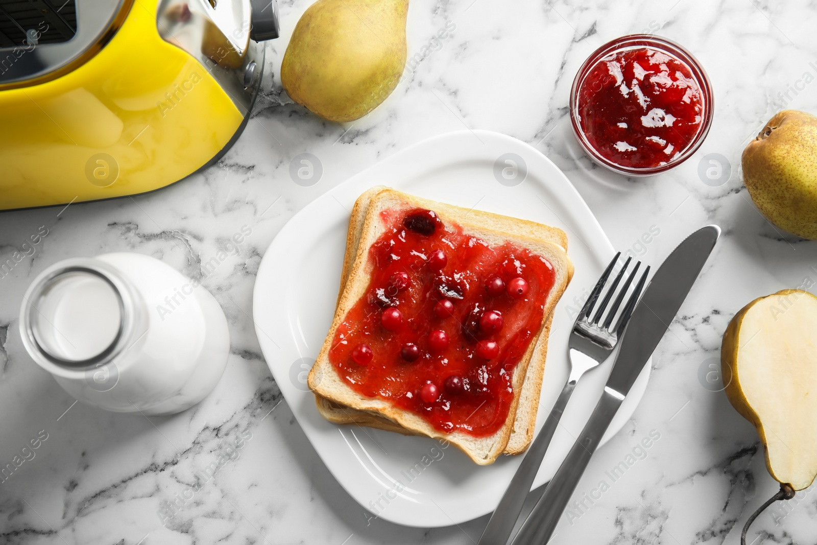 Photo of Slice of bread with jam on white marble table, flat lay