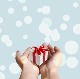 Image of Boxing day, banner design. Woman with gift on light background, closeup