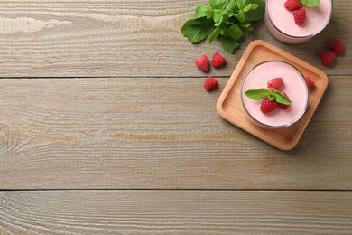 Delicious raspberry mousse with mint on wooden table, flat lay. Space for text