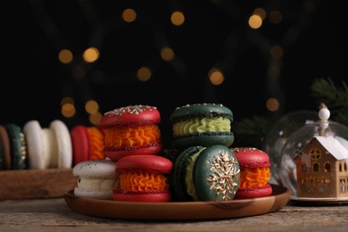 Beautifully decorated Christmas macarons and festive decor on wooden table