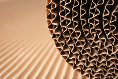 Photo of Closeup view of roll of brown corrugated cardboard, space for text. Recyclable material