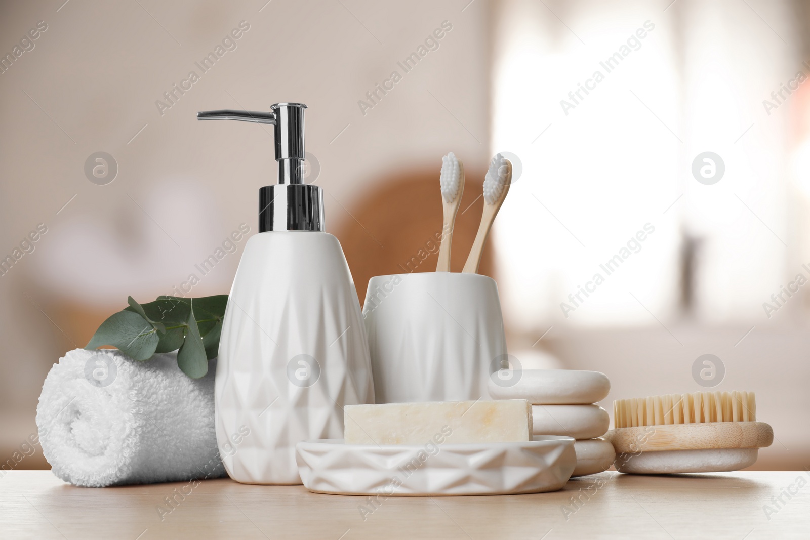 Image of Bath accessories. Different personal care products and eucalyptus leaves on wooden table in bathroom