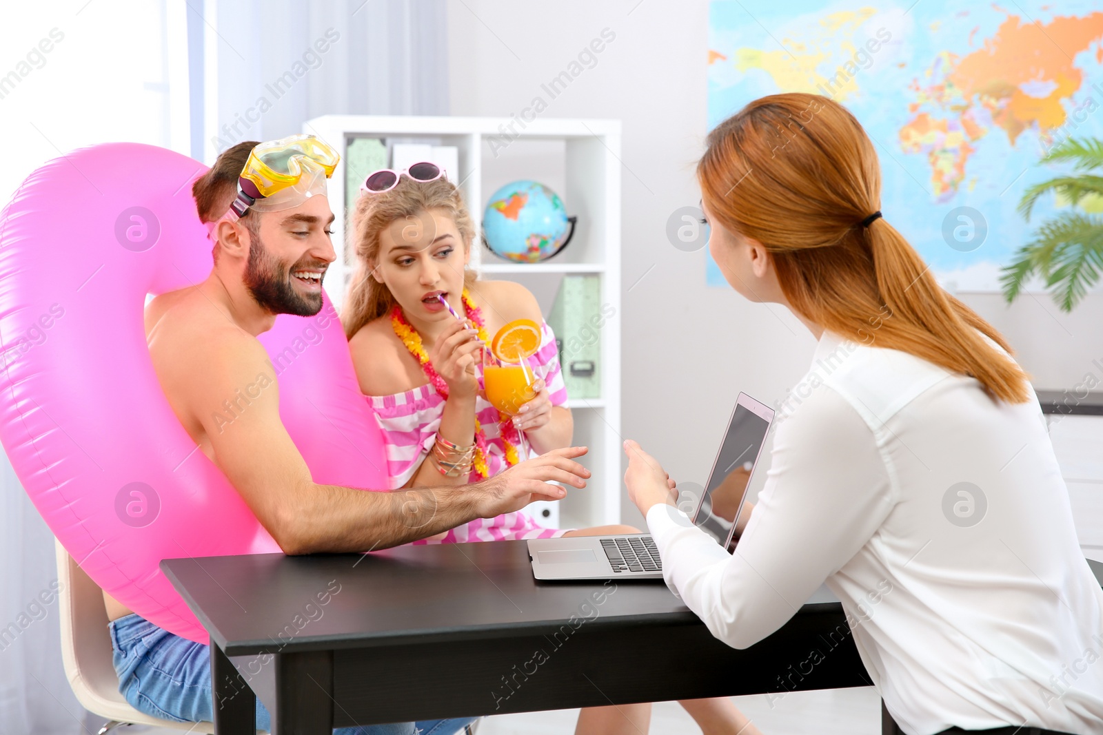 Photo of Beautiful young couple visiting travel agency office