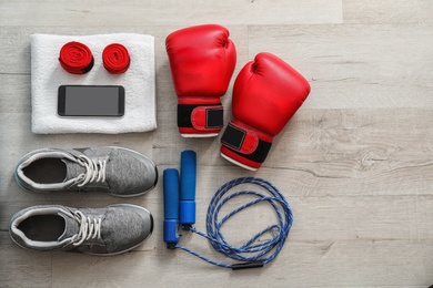 Photo of Flat lay composition with sports bag on wooden floor