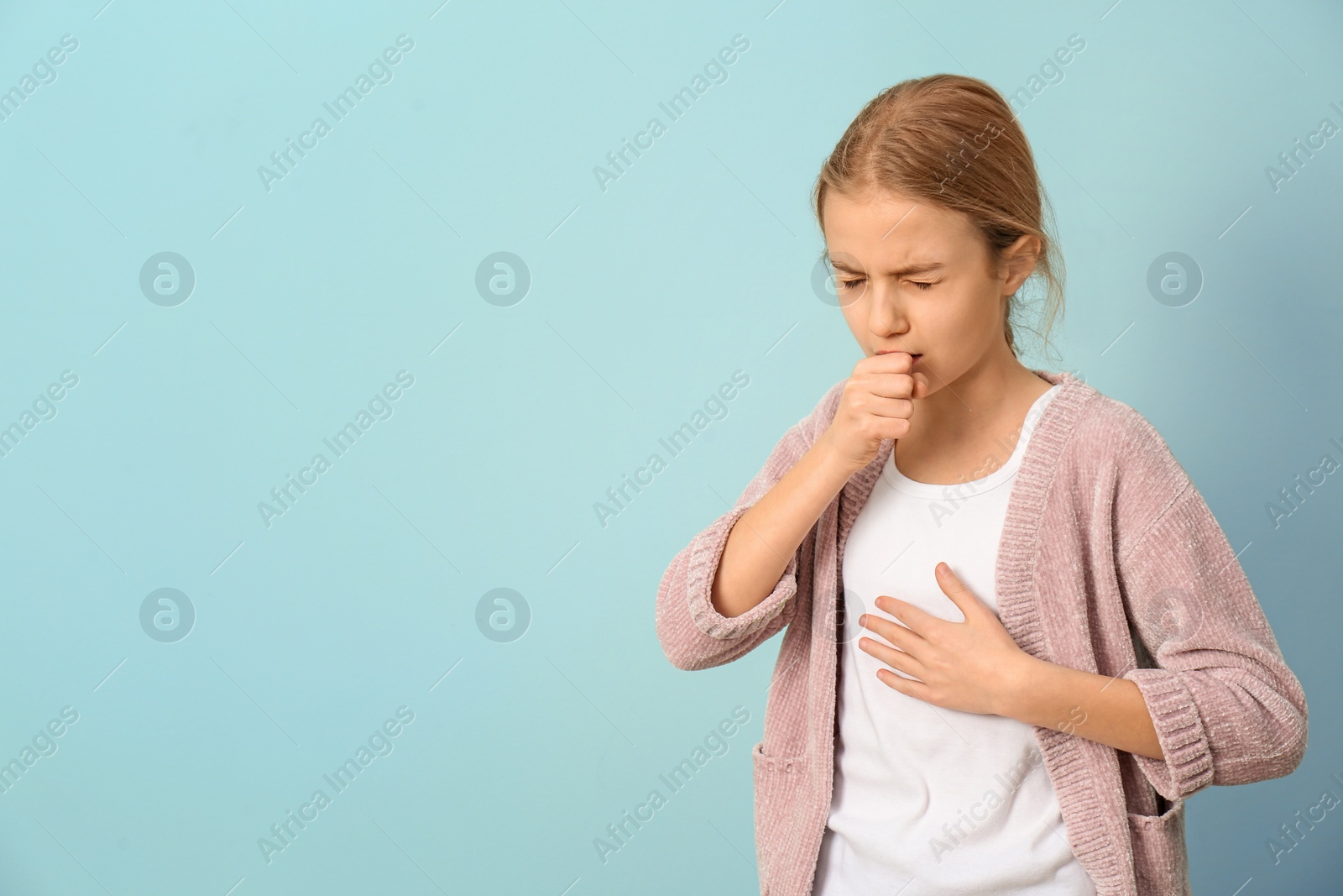 Photo of Girl coughing on color background