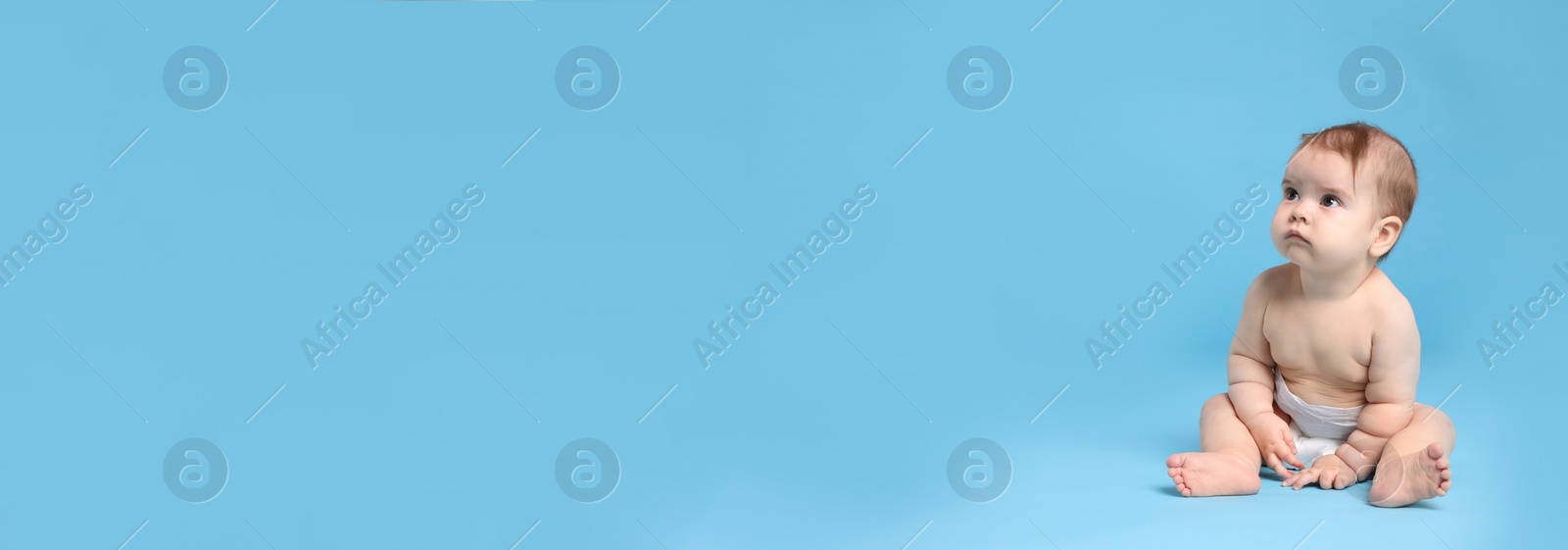 Image of Cute baby in diaper sitting on light blue background, space for text. Banner design