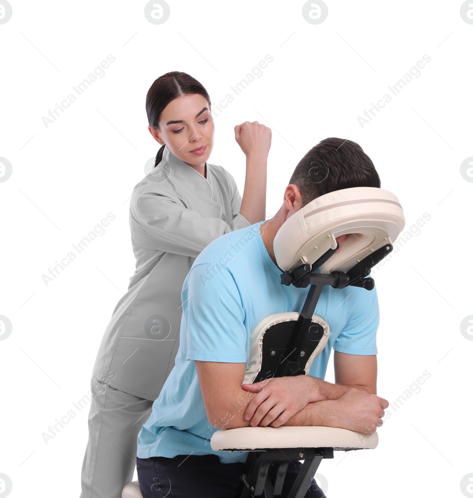 Photo of Man receiving massage in modern chair on white background