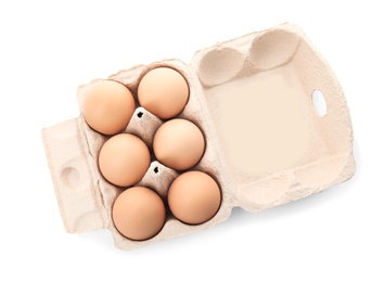 Photo of Carton of raw chicken eggs on white background, top view