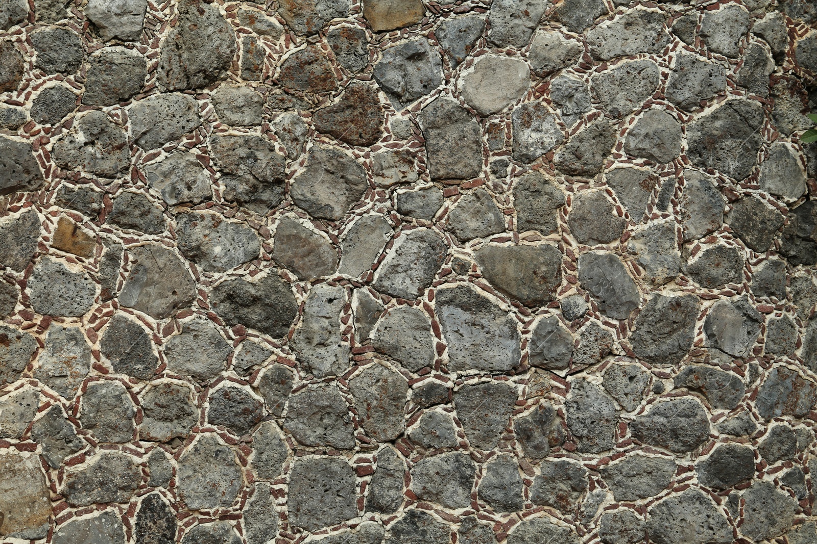 Photo of Texture of grey stone wall as background, closeup
