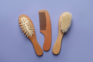 Photo of Bamboo brushes and comb on lavender background, flat lay. Conscious consumption