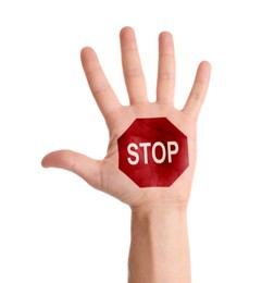 Image of Woman showing palm with drawn STOP sign on white background, closeup