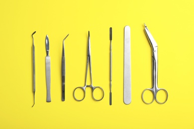 Photo of Set of medical instruments on color background, flat lay