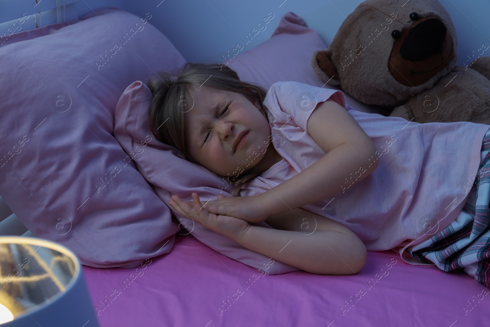 Photo of Little girl snoring while sleeping in bed at home