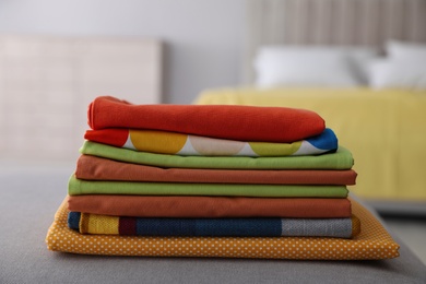 Photo of Stack of new clean folded bed linens on bench