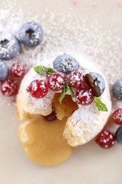 Tasty vanilla fondant with white chocolate and berries on white table, flat lay