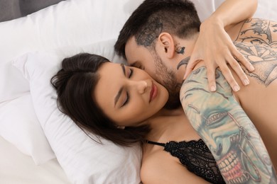 Passionate young couple having sex on bed