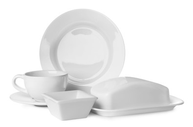 Photo of Set of clean tableware on white background
